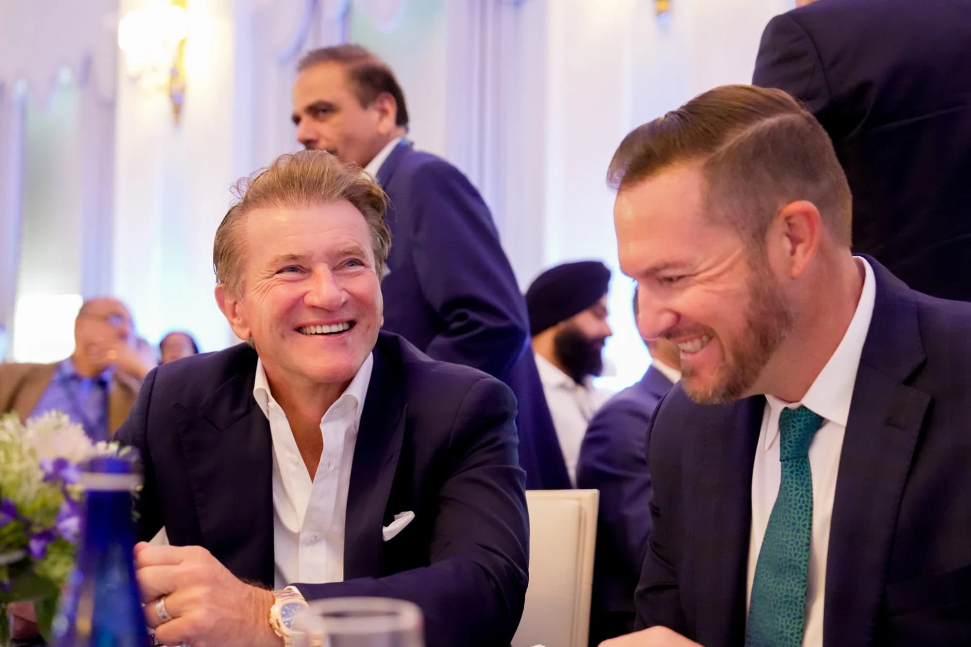Attendees sharing a laugh at dinner